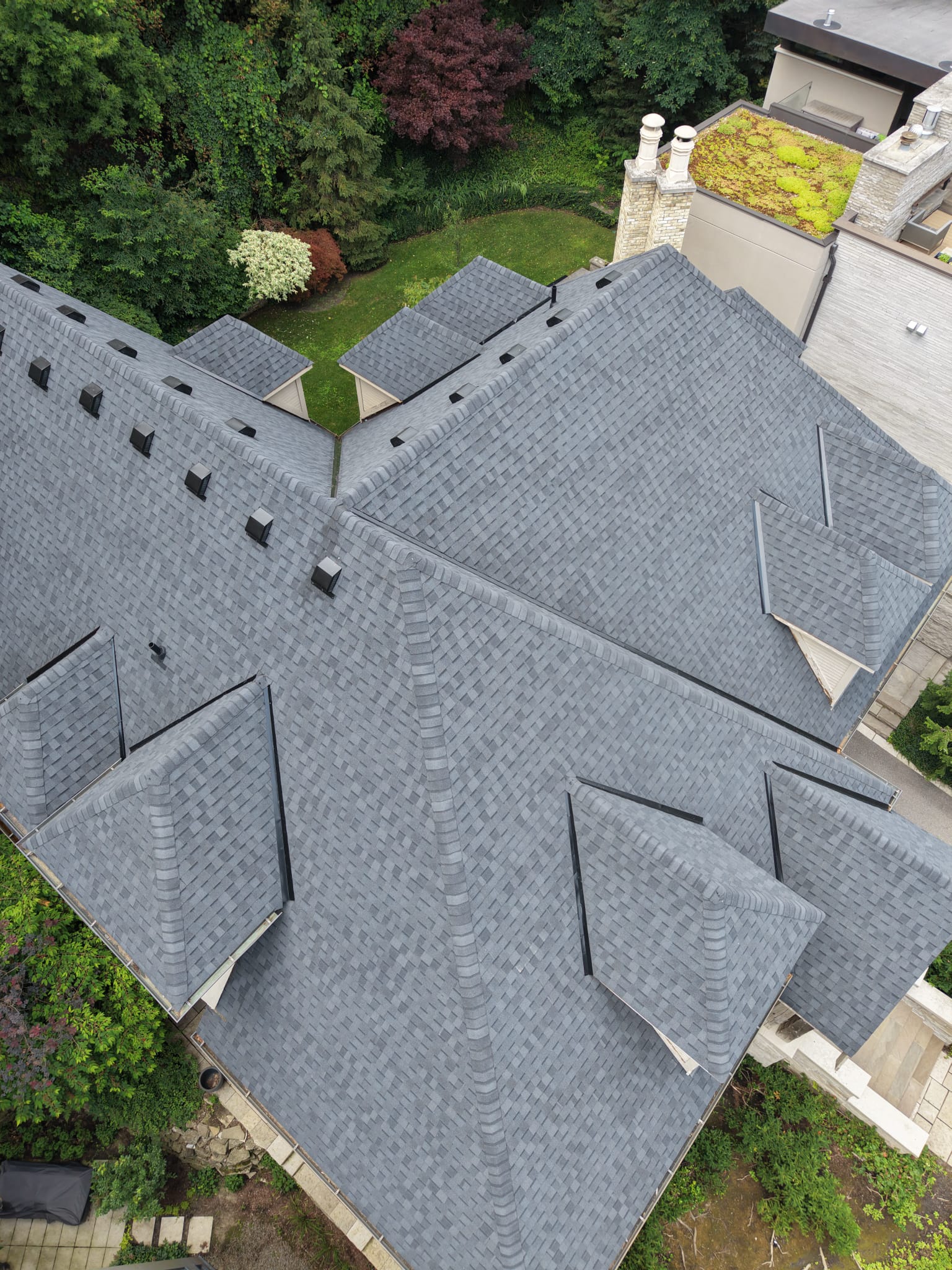 Standing seam metal and architectural shingle roofing details on a High Park Toronto home by Keen Roofing