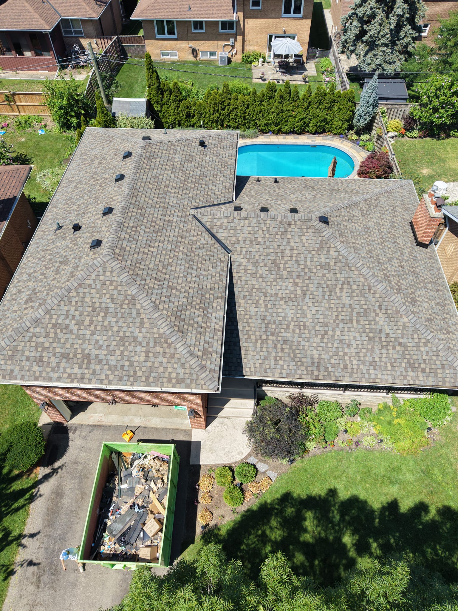Damaged asphalt shingles with missing granules and torn tabs on a residential roof in the Greater Toronto Area